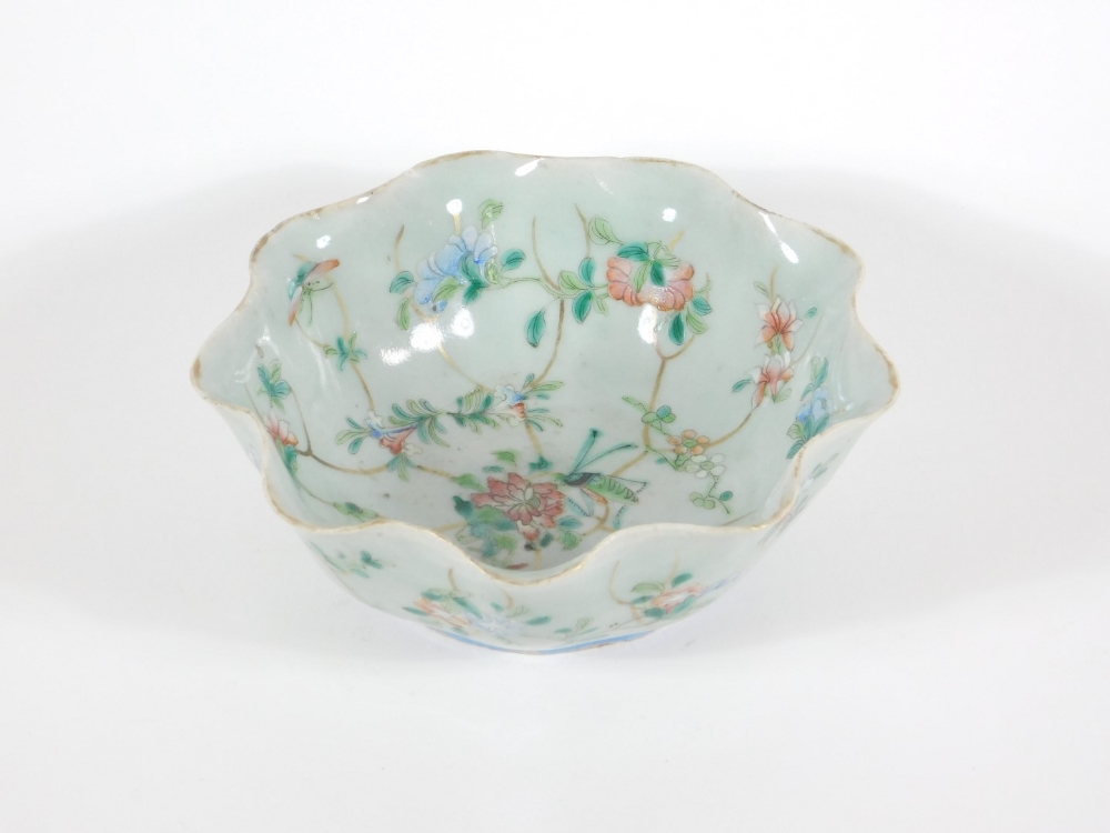 A 19thC celadon glazed Chinese porcelain bowl enamelled with peony branches, with wavy edge and