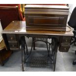 A Bradbury oak and iron treadle sewing machine.