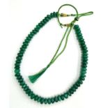 An emerald beaded necklace, with various round shaped earth mined rich green stones, totalling