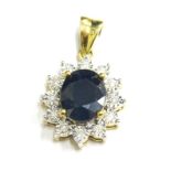 A 9ct gold sapphire and diamond pendant, with oval cut sapphire, surrounded by round brilliant cut