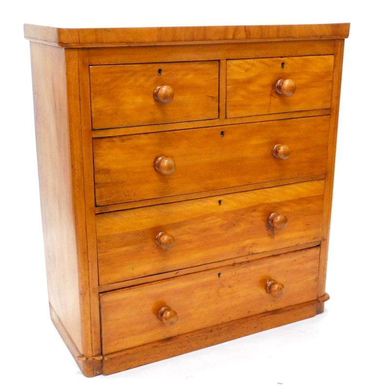 A Victorian satin walnut chest of drawers, with a plain top, above two short and three long drawers,