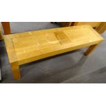 A modern oak bench, on square section legs, 130cm wide.