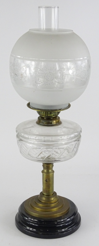 A Victorian brass oil lamp, with a frosted shade and cut clear glass reservoir, a brass