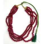 A ruby beaded necklace, with round beads, each earth mined, of four line design, totalling approx