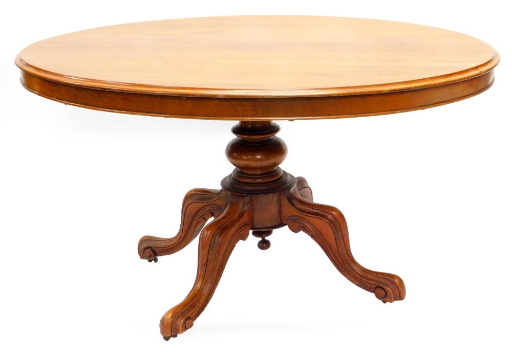 A Victorian mahogany oval breakfast table, the tilt top with a moulded edge, on a turned column