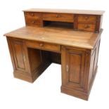 A 19thC and later continental oak desk, the raised back with five drawers, flanked by gothic