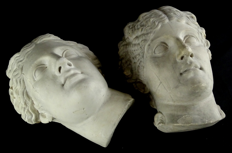 Two similar plaster wall masks, each cast in neoclassical style in the form of gentlemen, one