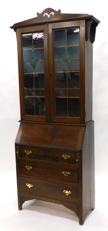 An Edwardian mahogany bureau bookcase, the top with a pierced crest, above two leaded glazed doors