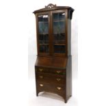 An Edwardian mahogany bureau bookcase, the top with a pierced crest, above two leaded glazed doors