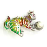 A plique-a-jour cat brooch, depicting a cat with red, yellow and green colouring, set with rubies