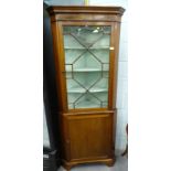 A mahogany standing corner cabinet, with single glazed door above a panelled door.