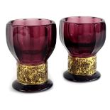 A pair of Moser type purple moulded glass vases, each with a band of figures, moulded in relief,