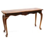 A walnut and ash side or serving table, the shaped top with a moulded edge, above a shaped apron