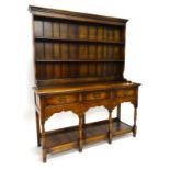 An oak dresser in the late 18thC style, the back with a moulded cornice above two shelves, the
