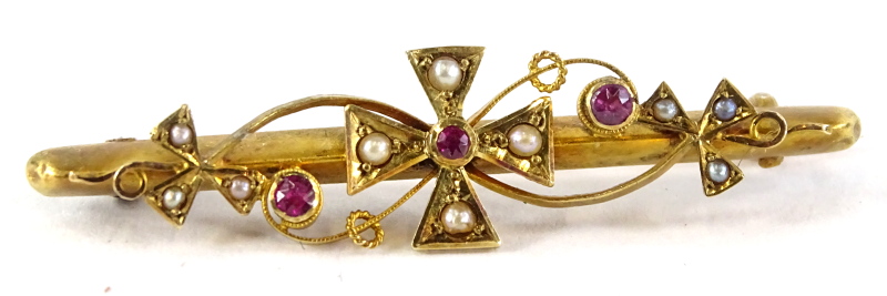 An early 20thC gold bar brooch, inset with seed pearls and rubies, stamped to the reverse 15ct. (2.