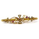 An early 20thC gold bar brooch, inset with seed pearls and rubies, stamped to the reverse 15ct. (2.