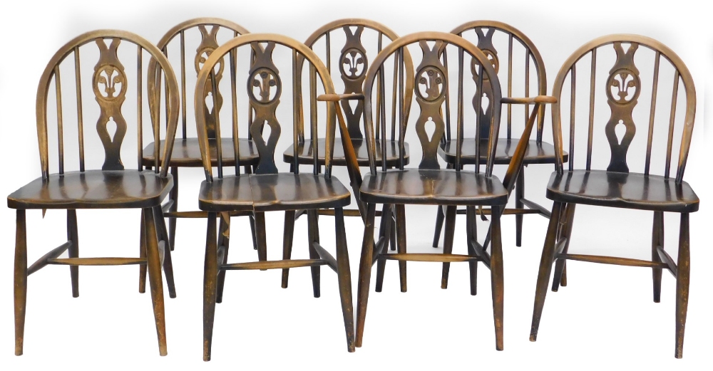 A set of seven Ercol stained beech Windsor type kitchen chairs, each with a pierced splat, a solid