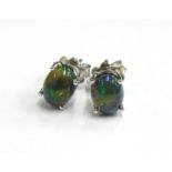 A pair of black opal earrings, each in basket setting, with butterfly backs, silver, 3.2g all in.