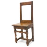A 17thC French oak chair or back stool, with a plain rectangular back, solid seat with a moulded
