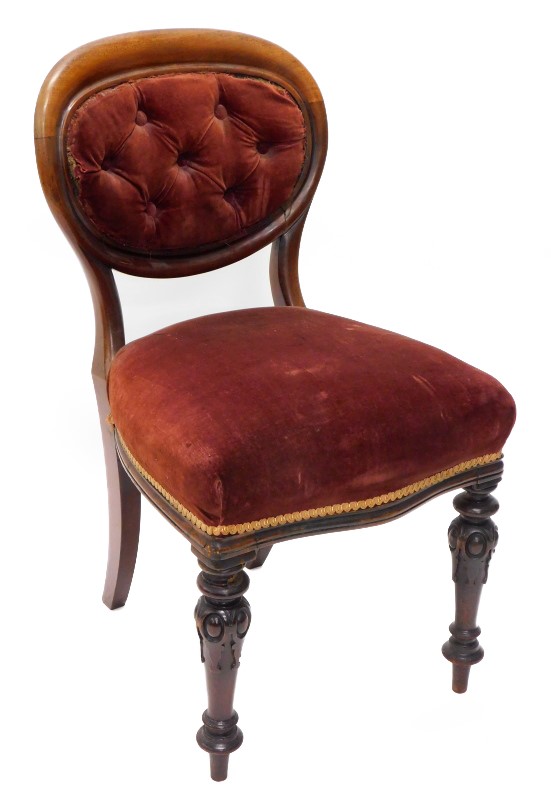 A Victorian mahogany balloon back side chair, with an oval back, upholstered in buttoned dark pink