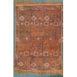 A Turkoman type rug, with a geometric design, on a brown ground, 114cm x 82cm.