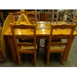 A stained hardwood refectory type kitchen table and four chairs, each with a rush seat.