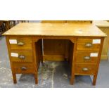 An oak office desk, with six drawers.
