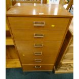 A G-Plan teak chest of six drawers, designed by E Gomme, on a metal base, 122cm high, 56cm wide.