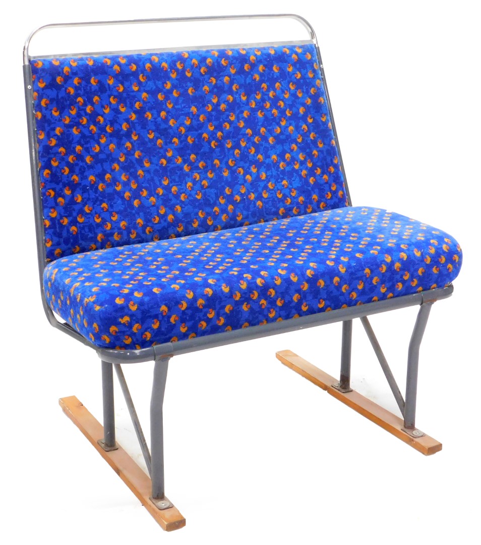 A chrome plated and upholstered bus seat, 76cm wide.