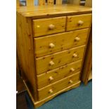 A pine chest of drawers, the top with a moulded edge above two short and four long drawers, each