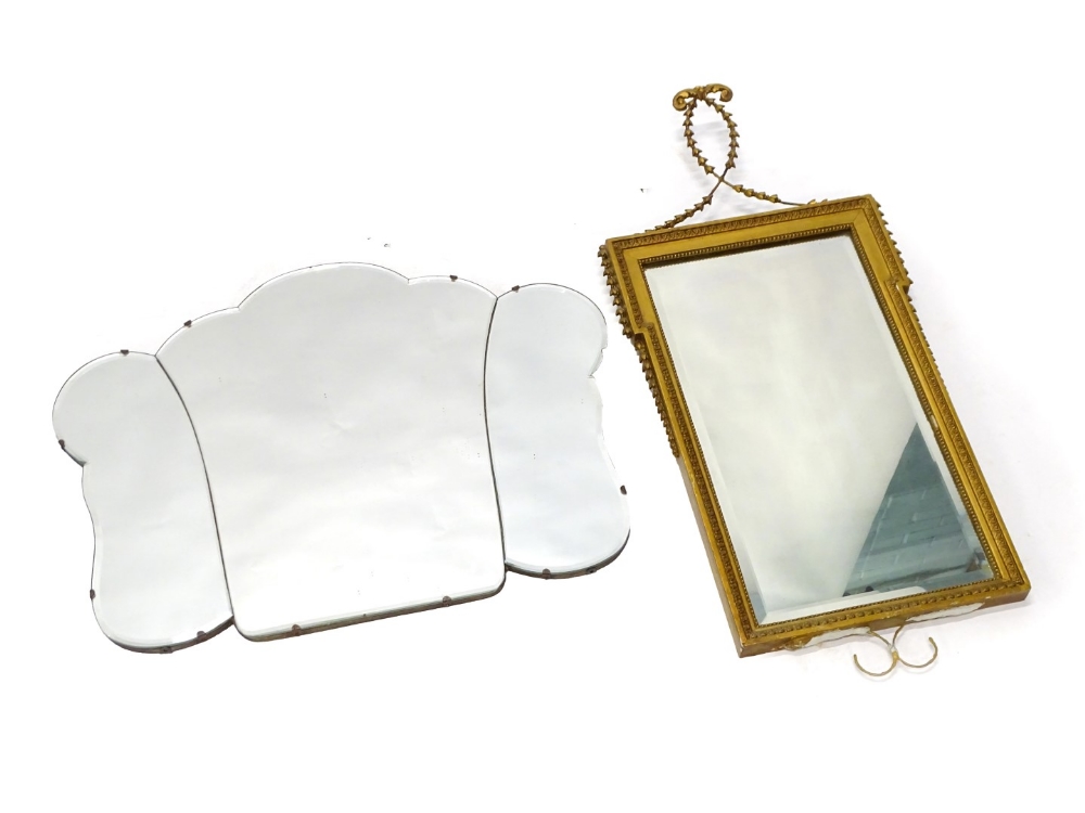 An Art Deco wall mirror of shaped form, with bevelled edge, 73cm wide, and a gilt wall mirror,