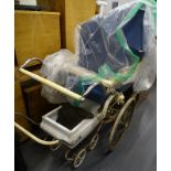 A Swan coach built pram with spoked wheels, painted in blue and white, and a Tri-ang childs pram. (