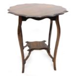 An Edwardian walnut two tier occasional table, the top with a moulded shaped edge, on cabriole