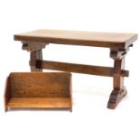 An oak coffee table, with a rectangular top on end supports, 70cm wide, and a small oak bookrack,