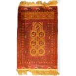 An Eastern prayer rug, with a design of six medallions on a brown ground, with multi borders,