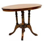 A Victorian walnut occasional table, the oval marquetry top on four turned supports with leaf carved