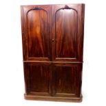 A Victorian mahogany wardrobe, with two doors, each with four panels on a plinth base, (AF,