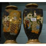 A pair of Japanese earthenware square section vases, each decorated with figures and with raised