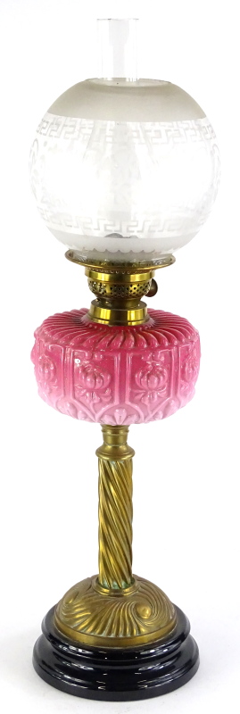 A Victorian brass oil lamp, with a frosted globular stencilled shade, a brass fitting stamped