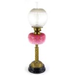 A Victorian brass oil lamp, with a frosted globular stencilled shade, a brass fitting stamped