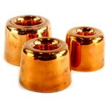 An associated graduated set of three copper jelly moulds, two stamped Jones Brothers, 4 Down