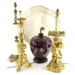 A continental gilt table lamp, cast with putto, etc., a similar church type candle stand, a globular