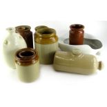 A collection of stoneware jars, a slipper bed pan, a bed warmer, etc.