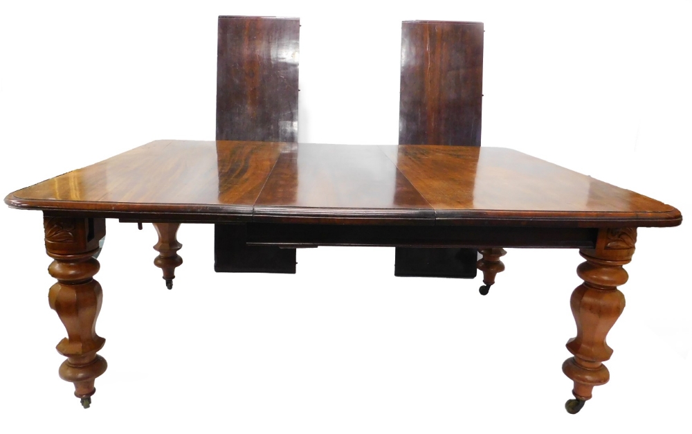 A Victorian mahogany extending dining table, the rectangular top with a moulded edge, on bulbous