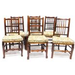 A Harlequin set of six 19thC Lancashire type spindle back dining chairs, each with a rush seat on