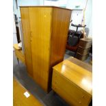 A retro teak bedroom suite, comprising wardrobe, chest of drawers and dressing table.