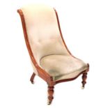 A Victorian stained beech nursing chair, with a padded back and seat, a moulded showframe, on turned