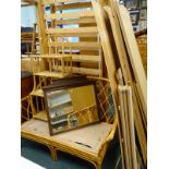 A pine effect bookcase, a pine effect flat pack wardrobe, a pair of pine single bed frames, a rattan