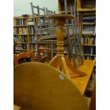 A circular kitchen table, on a beech pedestal base and four metal kitchen chairs.