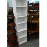 A graduated corner whatnot, a melamine bookcase, Edwardian corner chair, an oval coffee table. (4)
